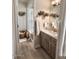 Bright bathroom featuring a glass-enclosed shower, wood-look vanity, and stylish decor at 1455 W Posada Ave, Mesa, AZ 85202