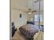 Cozy bedroom with ceiling fan, bed, dresser, and natural light at 1455 W Posada Ave, Mesa, AZ 85202