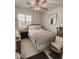 Well-lit bedroom with a neutral color scheme, cozy furnishings, and a large window at 1455 W Posada Ave, Mesa, AZ 85202