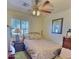 Bright bedroom with ceiling fan, bed, bedside tables, and shuttered window at 1455 W Posada Ave, Mesa, AZ 85202