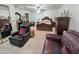 A well-lit bedroom features a plush recliner, a dresser, and carpet flooring at 1455 W Posada Ave, Mesa, AZ 85202