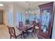 Formal dining room with a wood table, chandelier, and a china cabinet filled with dishware at 1455 W Posada Ave, Mesa, AZ 85202