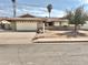 Charming single-story home with a well-maintained front yard and a two-car garage at 1455 W Posada Ave, Mesa, AZ 85202
