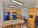 Well-lit kitchen featuring custom wood cabinetry, an island with seating, and modern appliances at 1455 W Posada Ave, Mesa, AZ 85202