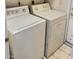 Functional laundry room features a matching washer and dryer set for added convenience at 1455 W Posada Ave, Mesa, AZ 85202