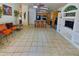 Open concept living area showcasing tile flooring and seamless transition into the kitchen at 1455 W Posada Ave, Mesa, AZ 85202