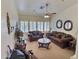 Comfortable living room featuring plush brown sofas, shuttered windows and decorative mirrors at 1455 W Posada Ave, Mesa, AZ 85202