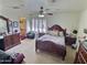 Large main bedroom featuring a ceiling fan, shuttered windows, and a connected bath at 1455 W Posada Ave, Mesa, AZ 85202