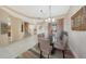 Bright dining room with glass table, soft chairs, and views into the living room and kitchen at 15040 E Scarlet Sky Ln # 4, Fountain Hills, AZ 85268