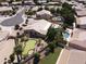 Aerial view of a beautiful home with a pool, putting green, and lush desert landscaping at 1544 N Rico Cir, Mesa, AZ 85213