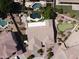 Stunning aerial view of a home with a dark swimming pool, a mini golf course, and desert landscaping at 1544 N Rico Cir, Mesa, AZ 85213