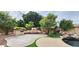 Backyard with outdoor kitchen, built-in grill, and lush greenery at 1544 N Rico Cir, Mesa, AZ 85213