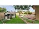 Backyard featuring a playhouse, a putting green, and stone pathways at 1544 N Rico Cir, Mesa, AZ 85213