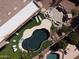 Aerial view of a backyard featuring a dark swimming pool, an outdoor kitchen, and a dining area at 1544 N Rico Cir, Mesa, AZ 85213