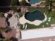 Overhead view of a beautiful backyard pool and patio area with turf and desert landscaping at 1544 N Rico Cir, Mesa, AZ 85213