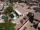 Aerial view of a home's backyard with a pool, patio, desert landscaping, and a mini golf course at 1544 N Rico Cir, Mesa, AZ 85213