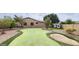 Backyard with a putting green, sand trap, playhouse, and lush landscaping at 1544 N Rico Cir, Mesa, AZ 85213