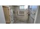 Bright tiled bathroom with walk-in shower and accessibility features at 1544 N Rico Cir, Mesa, AZ 85213
