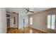 Light filled bedroom with ceiling fan, light walls, wood floors and plantation shutters at 1544 N Rico Cir, Mesa, AZ 85213