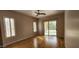 Bedroom with ceiling fan, wood floors and a glass sliding doors leading to the backyard at 1544 N Rico Cir, Mesa, AZ 85213