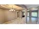 Formal dining room with statement light fixture, marble floors, and access to kitchen and living areas at 1544 N Rico Cir, Mesa, AZ 85213