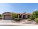Charming single-story home featuring a neutral stucco exterior, well-manicured landscaping, and a two-car garage at 1544 N Rico Cir, Mesa, AZ 85213