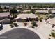 Aerial view of a charming home with a desert-landscaped front yard and a circular driveway in a cul-de-sac at 1544 N Rico Cir, Mesa, AZ 85213
