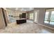 Spacious kitchen featuring an island, stainless steel appliances, modern lighting, and views of backyard at 1544 N Rico Cir, Mesa, AZ 85213