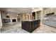 Open floor plan shows kitchen island with stainless steel sink and views to fireplace in living room at 1544 N Rico Cir, Mesa, AZ 85213