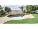A dark blue swimming pool surrounded by lush green landscaping at 1544 N Rico Cir, Mesa, AZ 85213