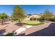 A backyard putting green featuring desert landscaping and a stone walkway at 1544 N Rico Cir, Mesa, AZ 85213