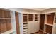 Spacious walk-in closet with custom shelving and wood accents that offers ample storage space at 1544 N Rico Cir, Mesa, AZ 85213