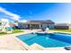 Resort-style backyard boasts sparkling pool, playground, lush greenery, and covered patio at 15802 N 50Th Dr, Glendale, AZ 85306