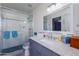 Bright bathroom with white tiled shower, granite countertop, and updated fixtures at 15802 N 50Th Dr, Glendale, AZ 85306