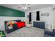 Inviting bedroom with dark blue accents, plush carpeting, ceiling fan, and cozy seating at 15802 N 50Th Dr, Glendale, AZ 85306