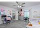 Light-filled bedroom featuring calming color palette, work space, and ceiling fan at 15802 N 50Th Dr, Glendale, AZ 85306