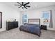 Spacious bedroom with neutral tones, modern fan, and ample natural light at 15802 N 50Th Dr, Glendale, AZ 85306