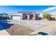 Charming single-story home with well-manicured front yard, desert landscaping and large driveway at 15802 N 50Th Dr, Glendale, AZ 85306
