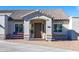 Inviting front entrance featuring a decorative front door, flowers, and stone walkway at 15802 N 50Th Dr, Glendale, AZ 85306