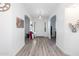 Bright hallway with hardwood flooring, decorative light fixture and arched doorways at 15802 N 50Th Dr, Glendale, AZ 85306