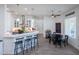 Modern kitchen featuring a breakfast bar, dining area, stainless steel appliances, and hardwood floors at 15802 N 50Th Dr, Glendale, AZ 85306