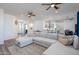 Open concept living space with large sofa, ceiling fans, and eat-in kitchen at 15802 N 50Th Dr, Glendale, AZ 85306