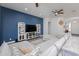 Comfortable living room with large television on console table and custom shelving at 15802 N 50Th Dr, Glendale, AZ 85306