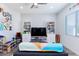 Playroom with shelves, TV, colorful decor and large window with blinds at 15802 N 50Th Dr, Glendale, AZ 85306