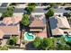 Aerial view of home featuring a pool, basketball court, well-maintained yard and solar panels at 16626 W Baden Ave, Goodyear, AZ 85338