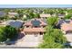 Aerial view of a two story home with a tile roof and solar panels surrounded by a lush green neighborhood at 16626 W Baden Ave, Goodyear, AZ 85338