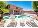 Relaxing backyard oasis featuring a sparkling pool, patio seating, and lush landscaping at 16626 W Baden Ave, Goodyear, AZ 85338