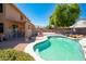 Private backyard pool with tanning ledge, lounge chairs and covered patio for outdoor entertaining at 16626 W Baden Ave, Goodyear, AZ 85338