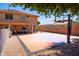 Full backyard view with a basketball court, covered patio, and well-kept gravel at 16626 W Baden Ave, Goodyear, AZ 85338