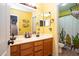 Well-lit bathroom featuring double sinks, ample counter space, and a shower with a cactus-themed curtain at 16626 W Baden Ave, Goodyear, AZ 85338